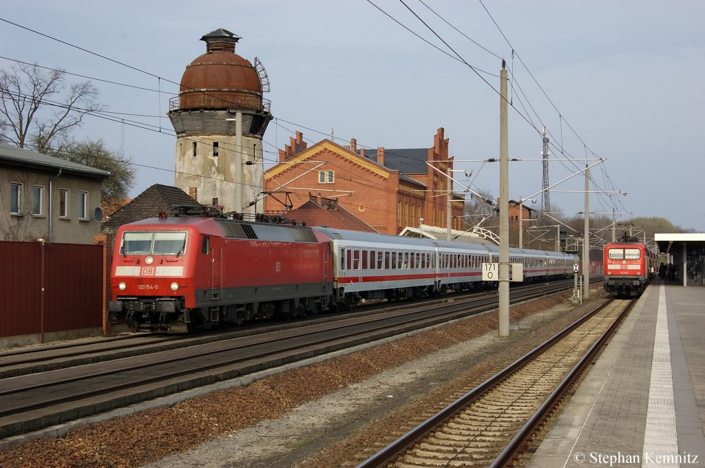 120 154-0 mit dem IC 1225 von Berlin Hbf (tief) nach Kln Hbf in Rathenow. In Bahnhof steht die 112 122 mit ihrem RE2 nach Knigs Wusterhausen. 03.04.2011