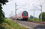 Durch Vietznitz kommt gerade eine RE4  Ersatzgarnitur  als (RE 37331) von Wittenberge nach Jterbog gefahren. Geschoben wurde von der 114 017. 12.07.2011